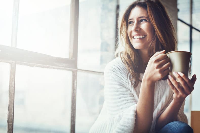 women-smiling-with-coffee-cup