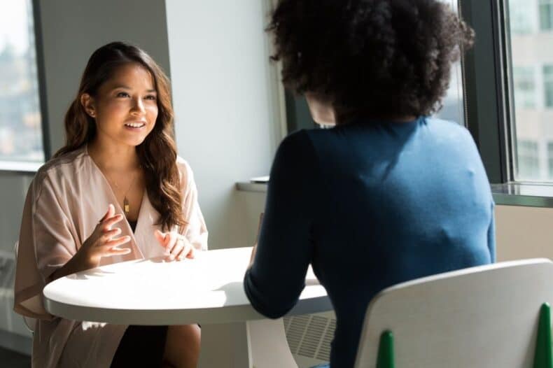 women-talking-at-a-table