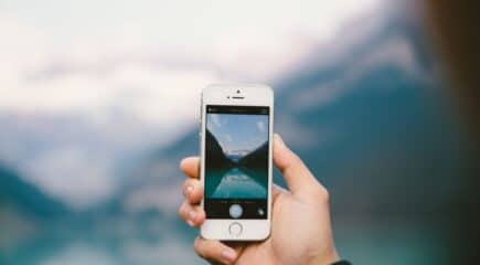 person-taking-photo-of-mountains-on-iphone